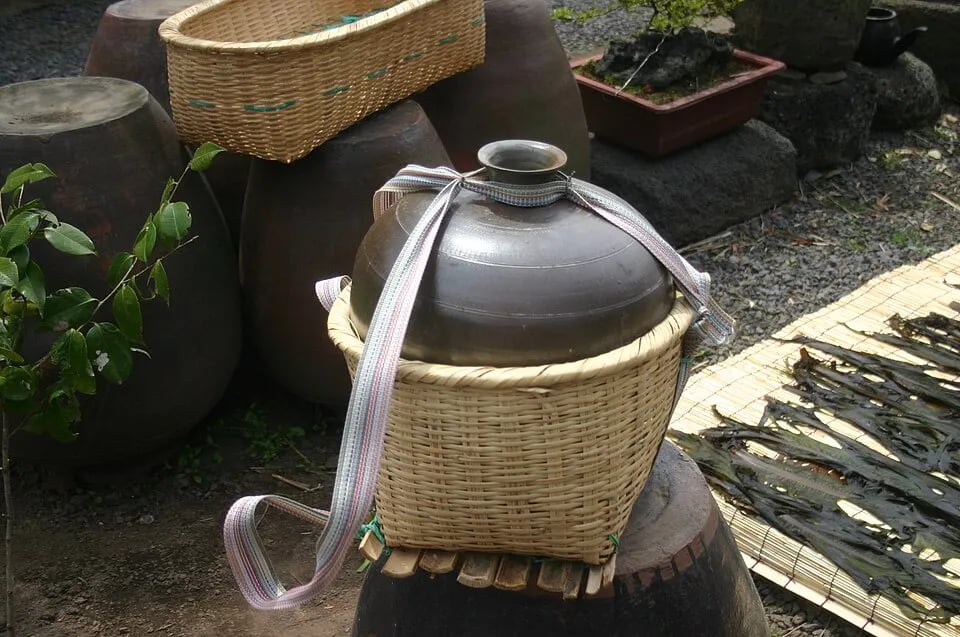 Traditional Korean onggi earthenware jars stand together outdoors.