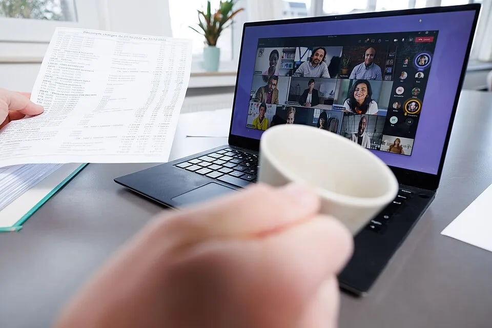 A person works at a laptop at home.