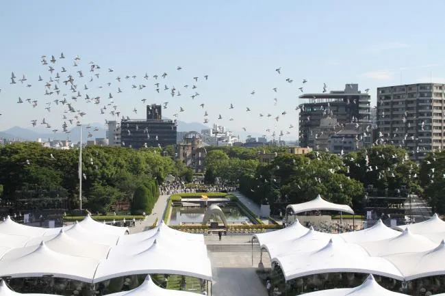 White doves fly above Hiroshima Peace Memorial Park during a memorial ceremony.