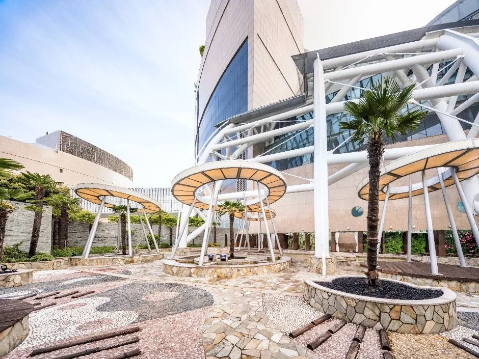 Visitors relax inside a modern Korean jjimjilbang with heated rooms and shared spaces.
