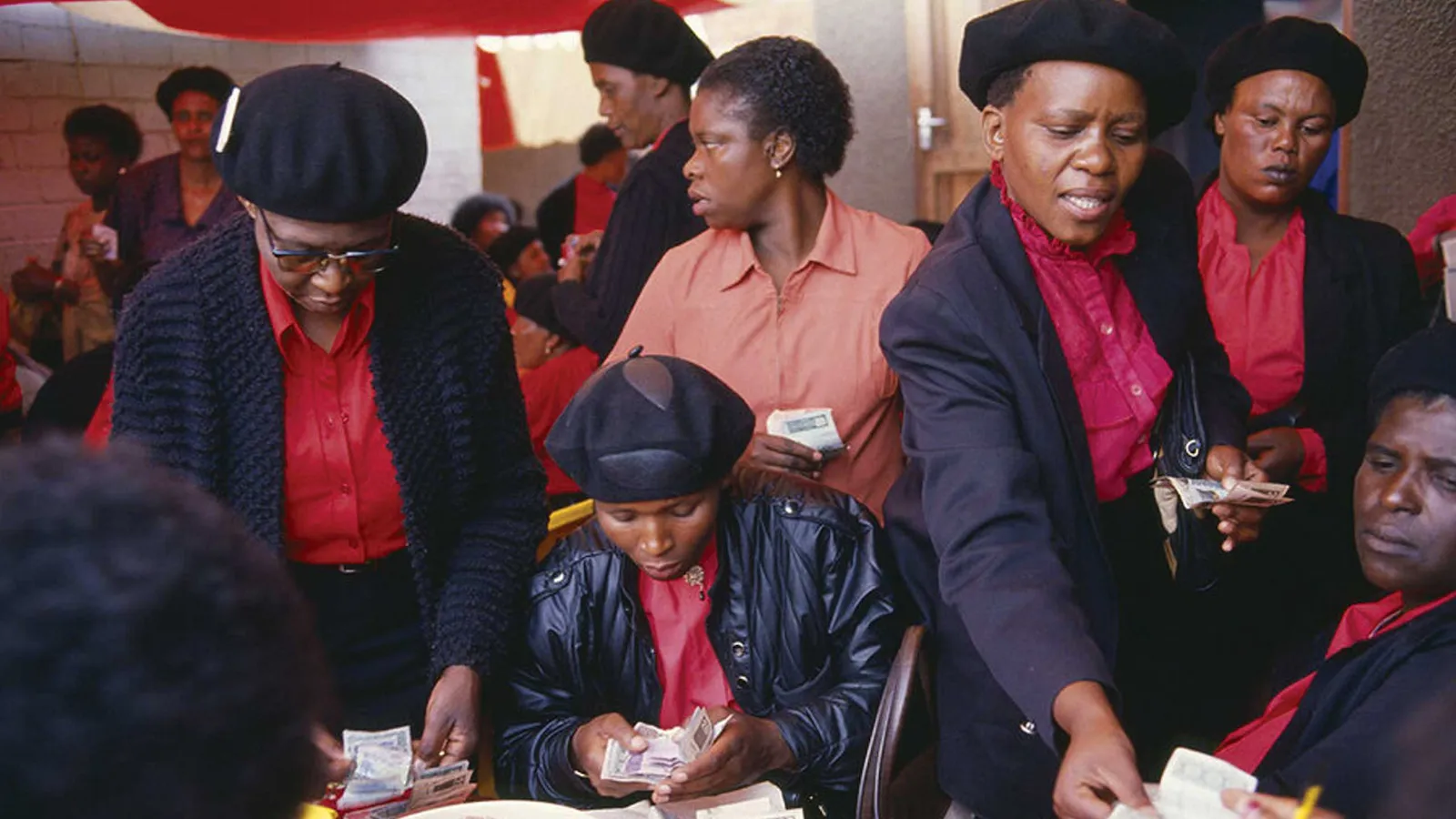 Members of a South African stokvel count cash together in Alexandra Township.