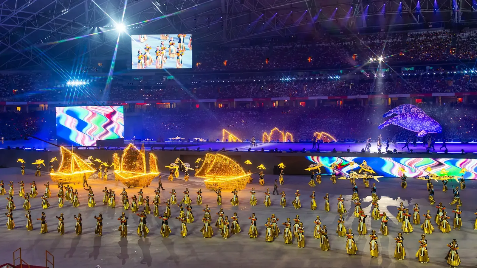 Performers use illuminated props during a National Day Parade show inside Singapore's National Stadium.