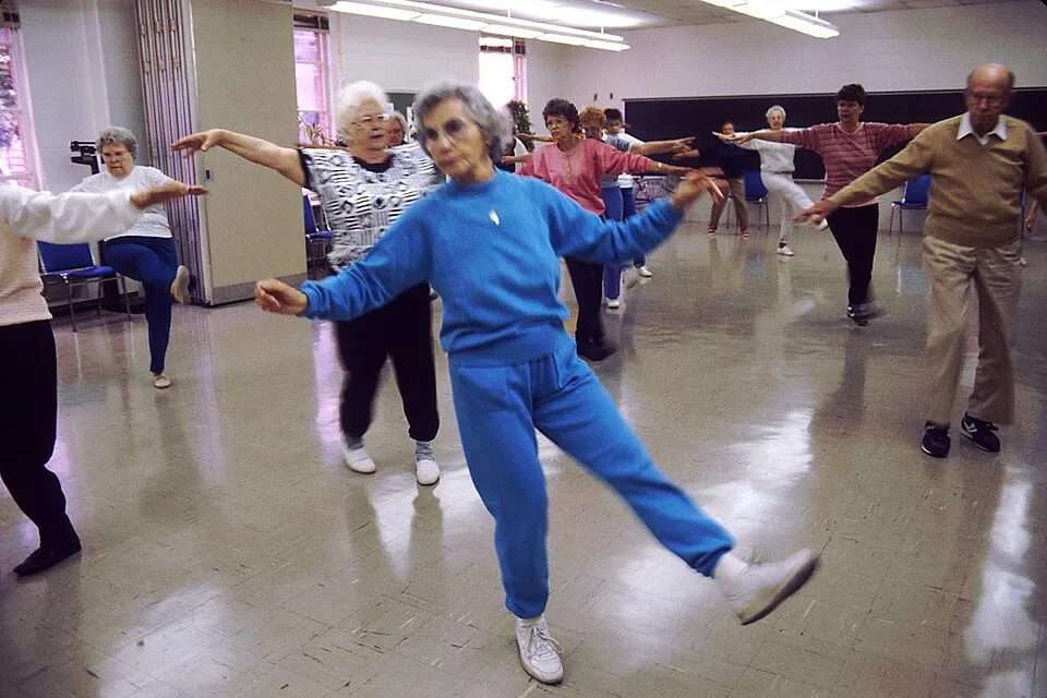 Older adults take part in an aerobics class, illustrating physical fitness in later life.