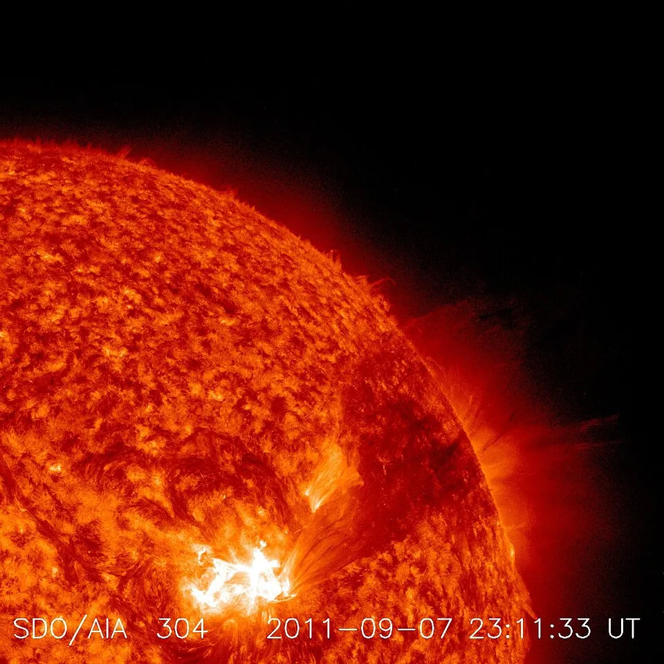 NASA imagery shows a bright solar flare and material erupting from the Sun.