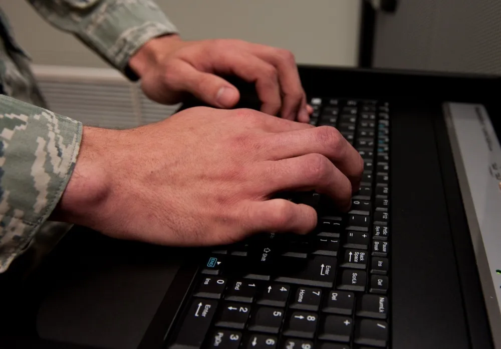 A person typing on a keyboard.